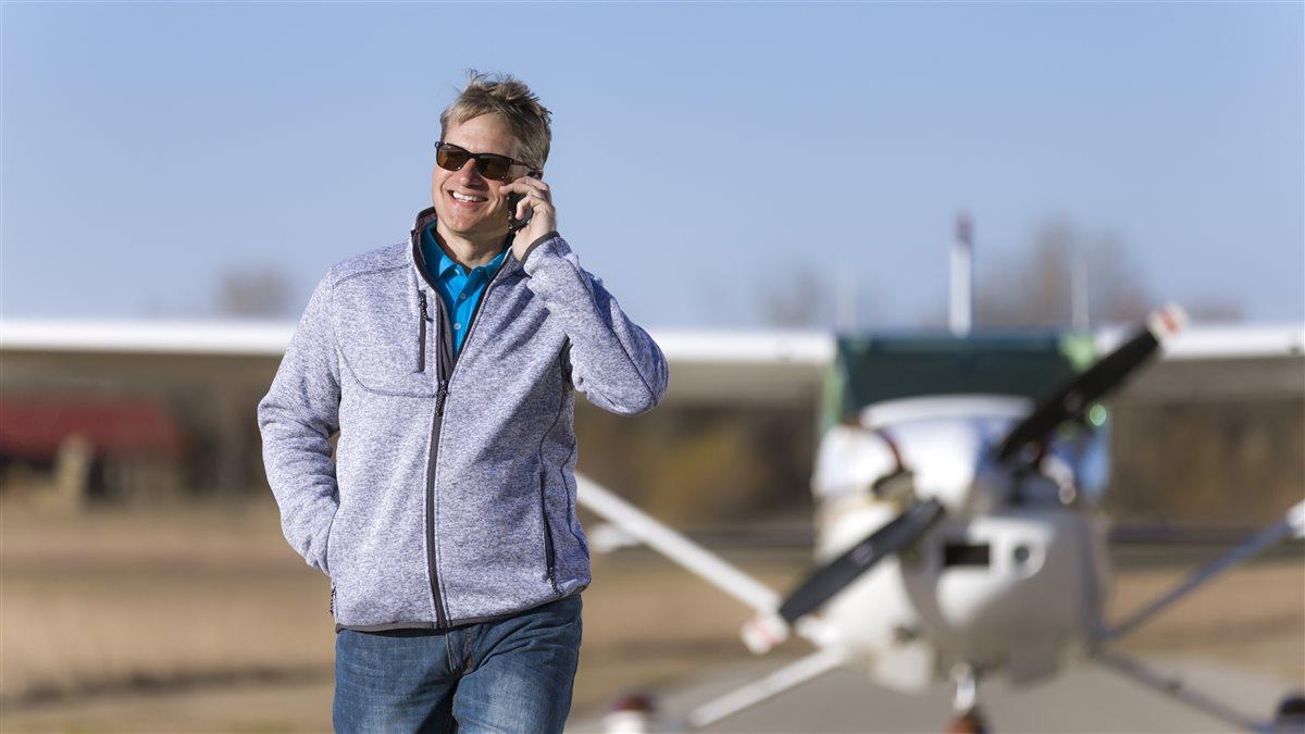 Model Lawson Phillips wearing a Men's Sweater Fleece Jacket (SKU# AOPA-MSFGR5-4) and a Pounce Puma Polo (SKU# AOPA-MPPBL5-4) with a Cessna 182.
Cook Airfield (K50)
Derby KS USA