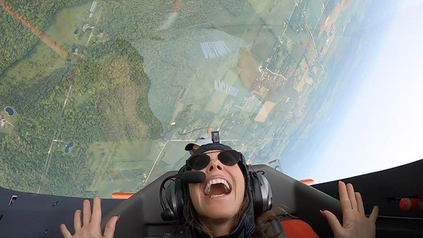 I Heart Flying foundation founder Rachelle Spector reacts during an aerobatic loop with the Phillips 66 Aerostars  during EAA AirVenture July 28. Spector’s foundation has awarded more than $100,000 in flight training scholarships to women. Photo courtesy of Phillips 66 Aerostars.