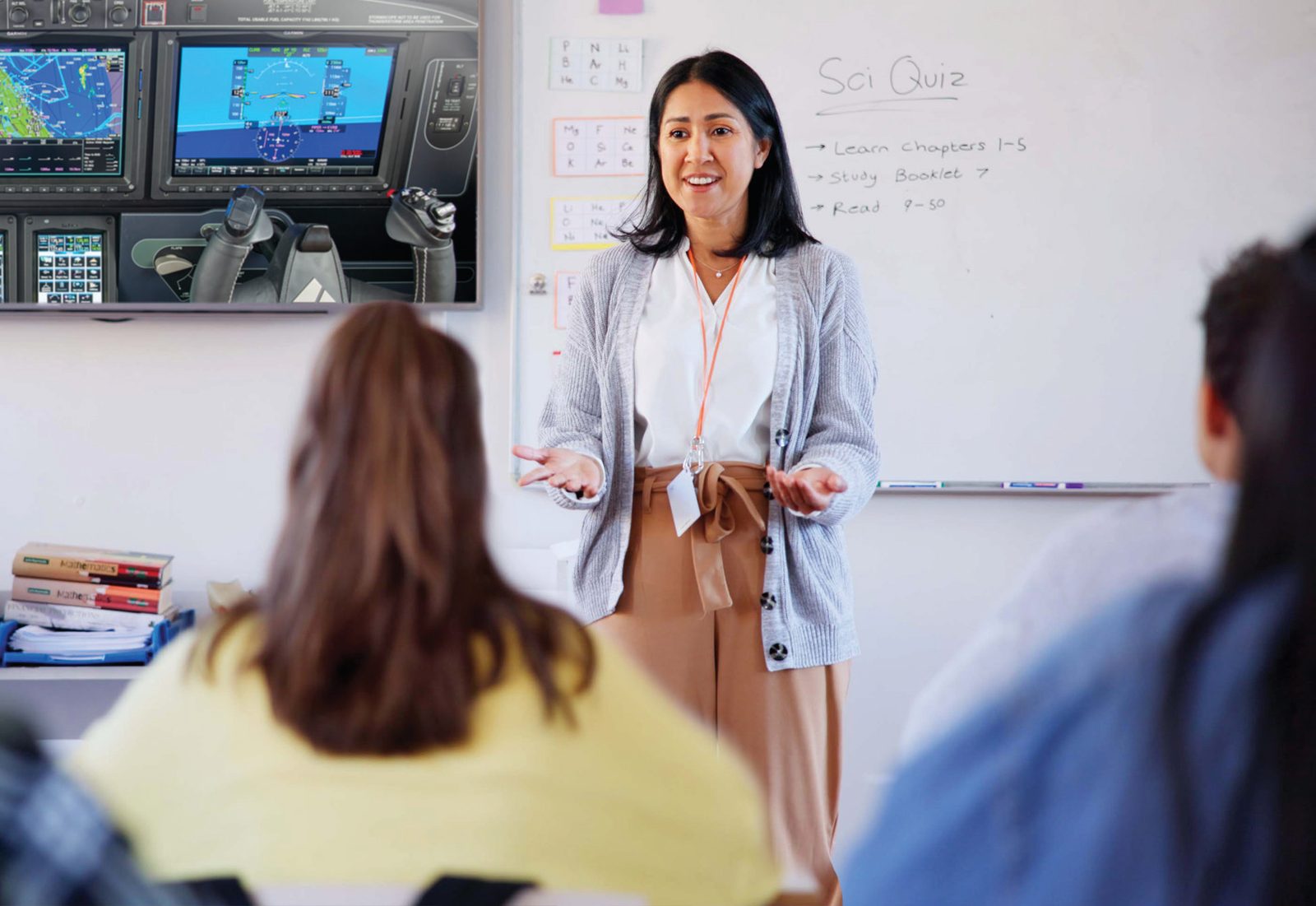 A classroom of students engaged with an aviation volunteer